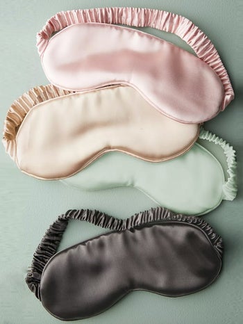 the pink, beige, green, and black eye masks
