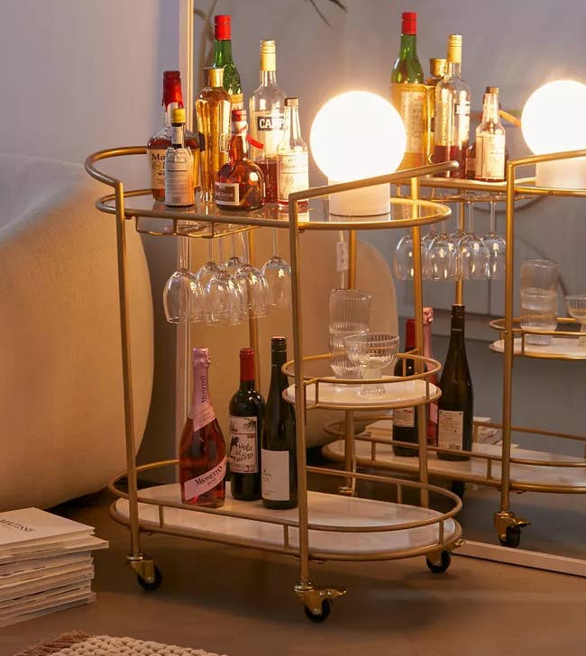 Image of the gold bar cart with glasses and bottles