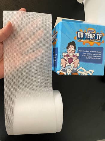a reviewer showing the fake TP and the box it comes in
