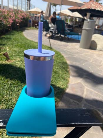 a reviewer's cup inside the blue clip cupholder