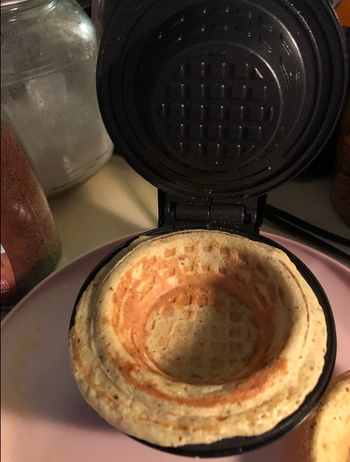 Closeup of a small mini waffle bowl made in a black device 