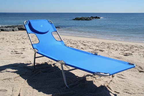 the blue chaise lounge on a beach