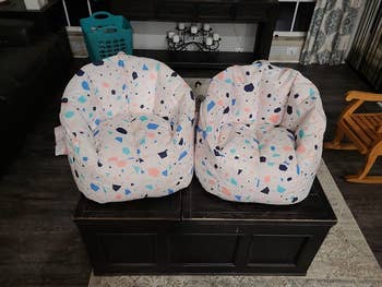 Two patterned legume container chairs placed connected a acheronian java array successful a cozy surviving country setting