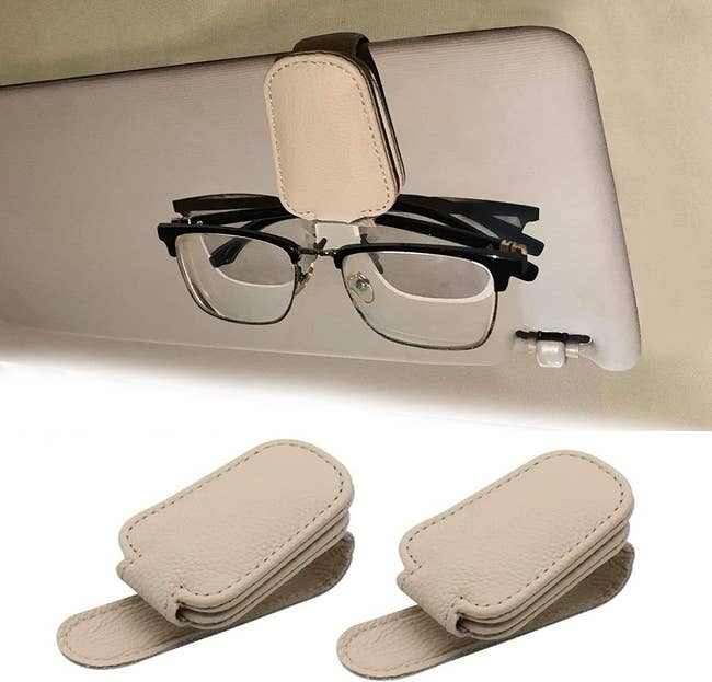 A beige pleather glasses holder magnetized to a car visor 
