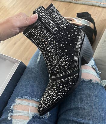 Image of reviewer holding black bootie