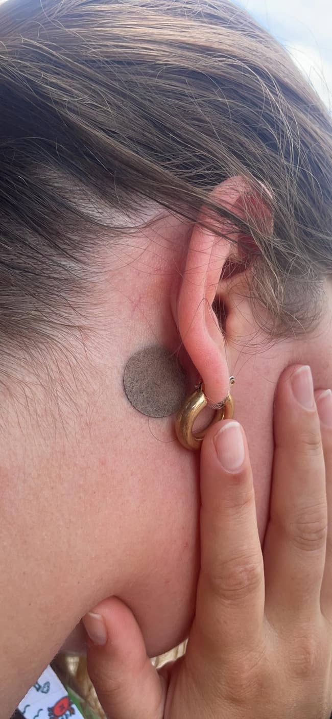 reviewer with the patch stuck behind ear