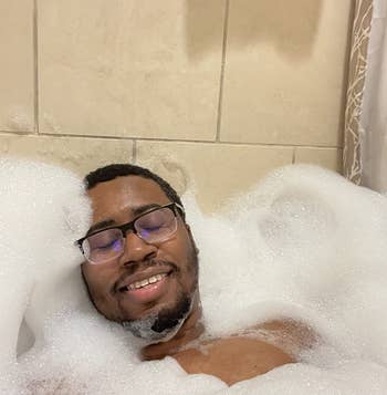 reviewer relaxing in a super bubbly bath