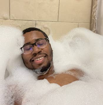 reviewer relaxing in a super bubbly bath