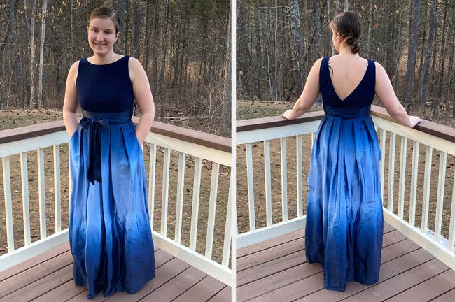 Reviewer showing front and back view of navy blue high neck and blackless sleeveless dress with matching bow around bodice and ombre blue skirt, while standing on wooden porch