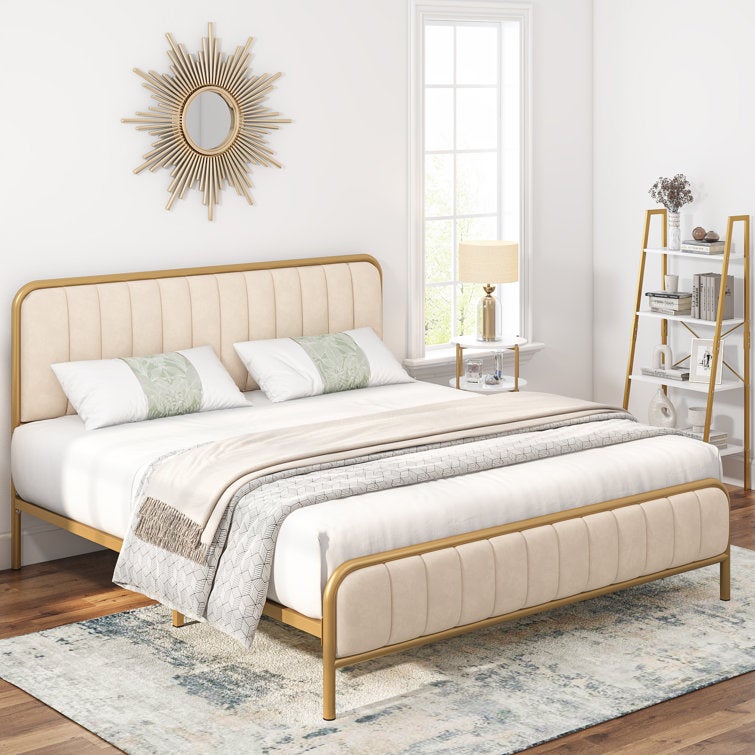 a cushiony white bed frame with gold trim