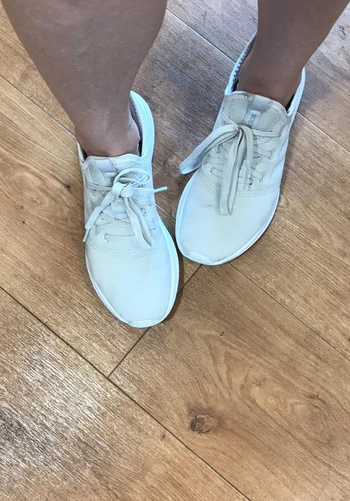 reviewer wearing the sneakers in white