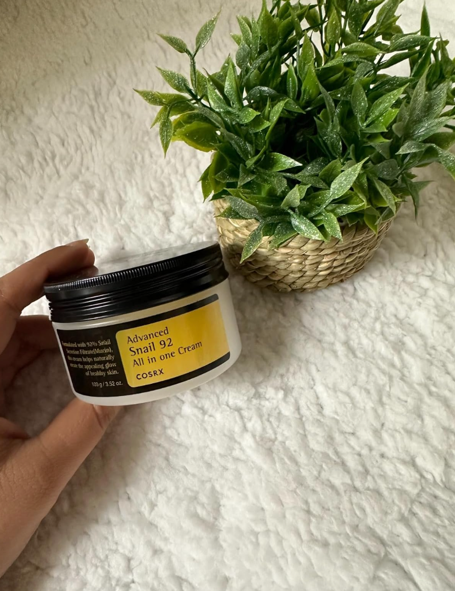 reviewer holding jar of moisturizer