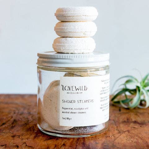 Jar of Lovewild Design ablution  steamers connected  a woody  surface, with a stack of steamers connected  the lid. Ingredients see  peppermint and eucalyptus