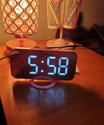 reviewer's alarm clock showing the time on a table with low light 