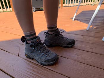 the same reviewer wearing hiking socks and shoes