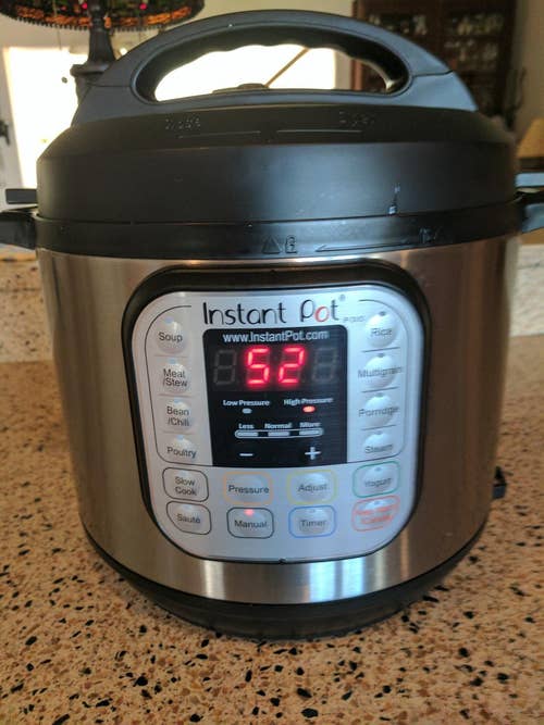 Instant Pot on a kitchen counter displaying a digital readout of 