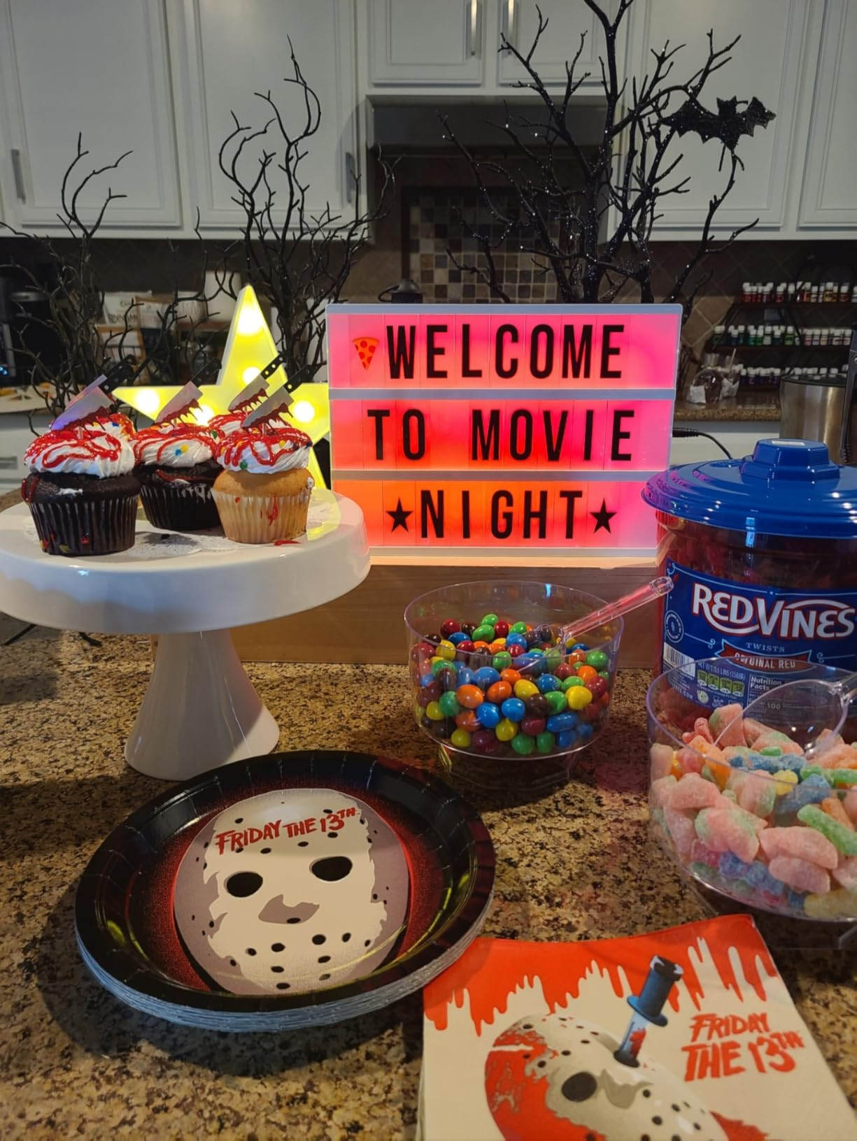 Movie nighttime  setup with cupcakes, candy, and a 