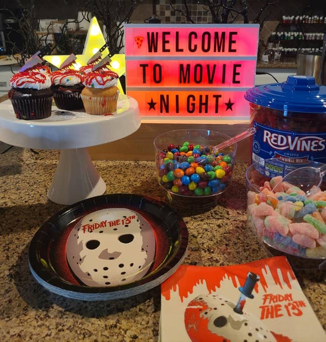 Movie nighttime setup with cupcakes, candy, and a