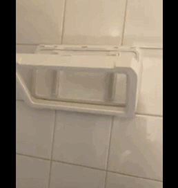 a reviewer rotating the shower phone holder 