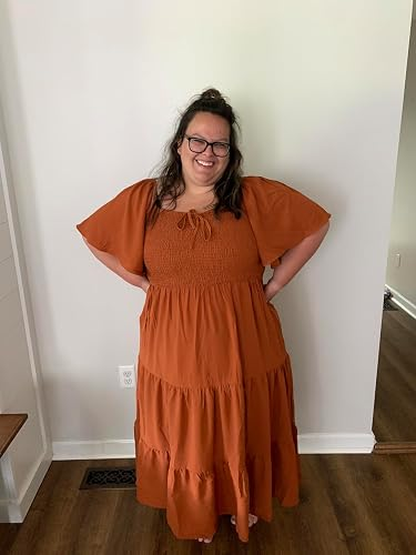 Person smiling successful  a flowing, tiered formal  with puff sleeves, lasting  successful  a country   with hands connected  hips