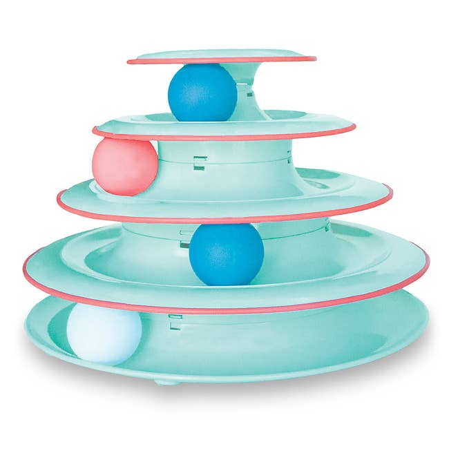 Seafoam structure with four tracks on top of each other, each with a blue, pink, or white ball