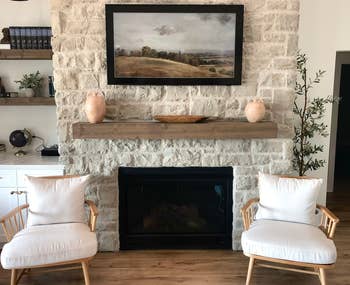 floating rustic mantle installed above fireplace