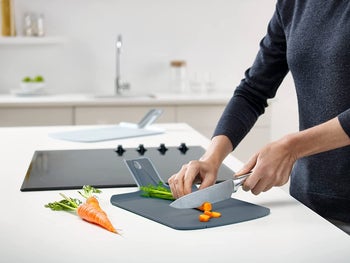 person chopping carrots on the cutting board