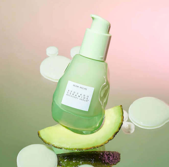 a small glass bottle filled with green serum