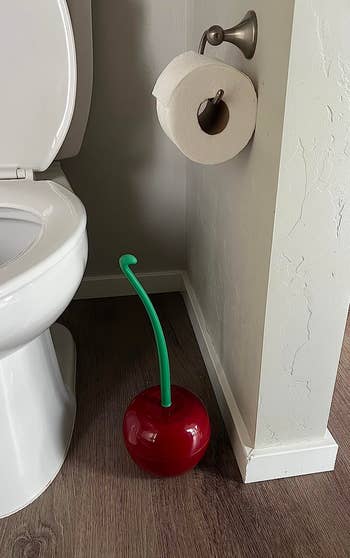 cherry toilet brush and holder in a reviewer's bathroom
