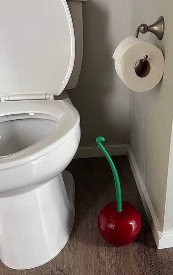 cherry toilet brush and holder in a reviewer's bathroom
