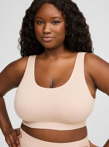 Person wearing a ribbed, sleeveless harvest  top, suitable for activewear oregon  casual style