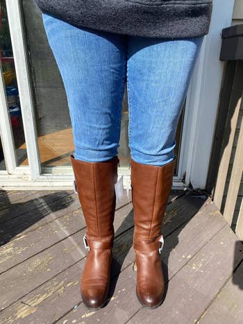 reviewer wearing the darker brown riding boots
