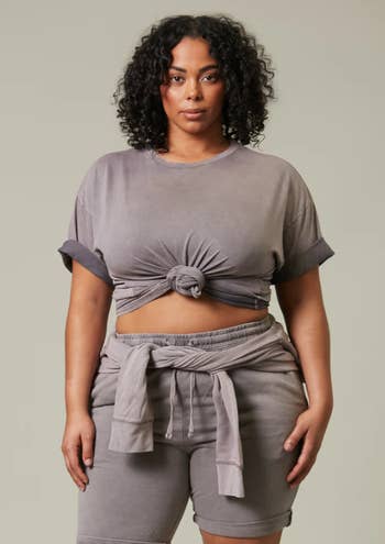 model in a knotted gray crop top and matching shorts
