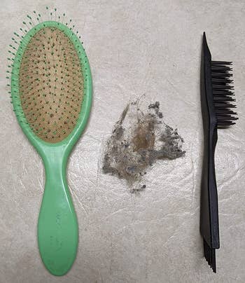 same reviewer's after photo showing their hairbrush without lint next to the cleaning brush, with a pile of lint that was removed between them
