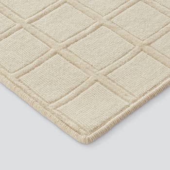 an ivory hand-carved tufted rug