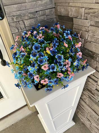 reviewers faux blue and pink flowers in outdoor planter