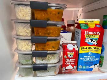 Five of the containers stacked in reviewer's fridge