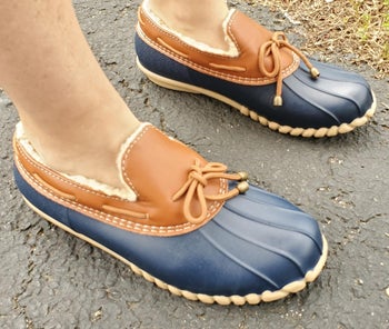 reviewer wearing the ankle duck shoes in brown and blue