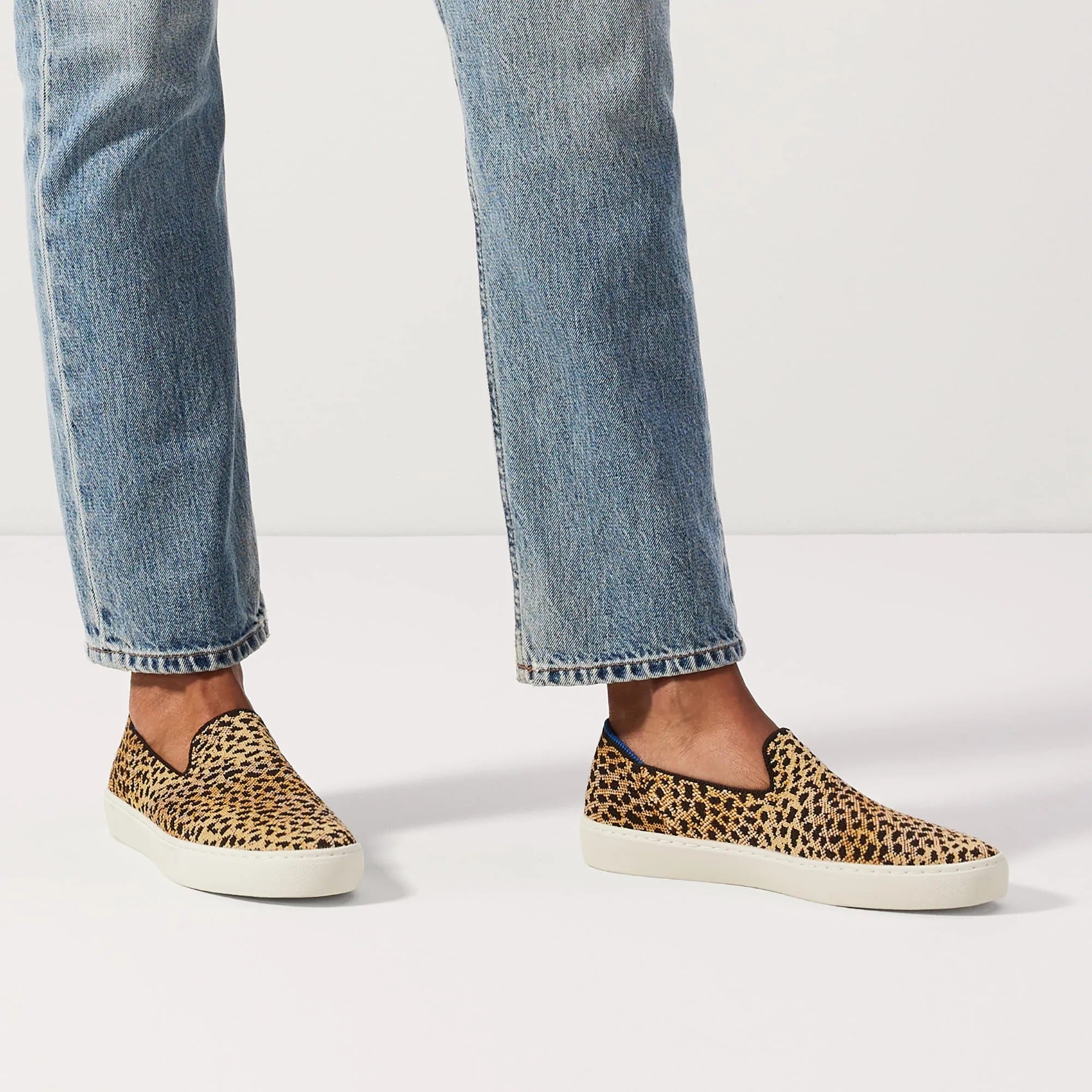 model wearing the slip-on sneakers in Sahara cat design