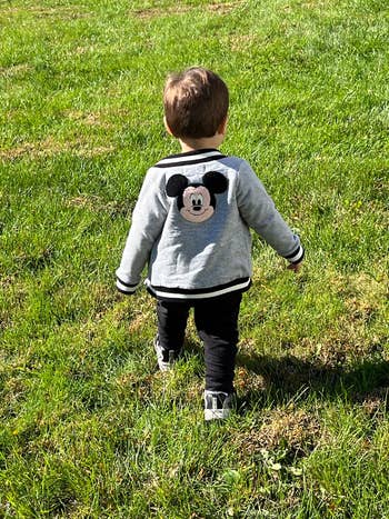 buzzfeed editor's son wearing a bomber jakcet with mickey embroidered on the back