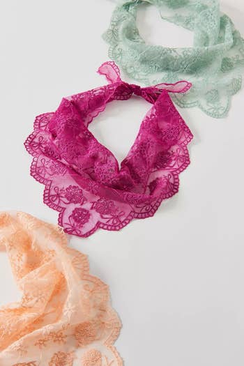 Three delicately embroidered lace scarves displayed, highlighting intricate patterns and differing textures for a fashionable accessory collection
