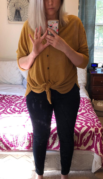 Another reviewer wearing the dark wash leggings with mustard yellow top