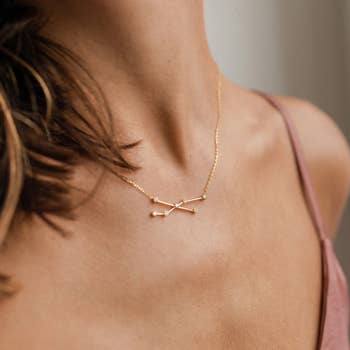 model wearing the taurus constellation necklace