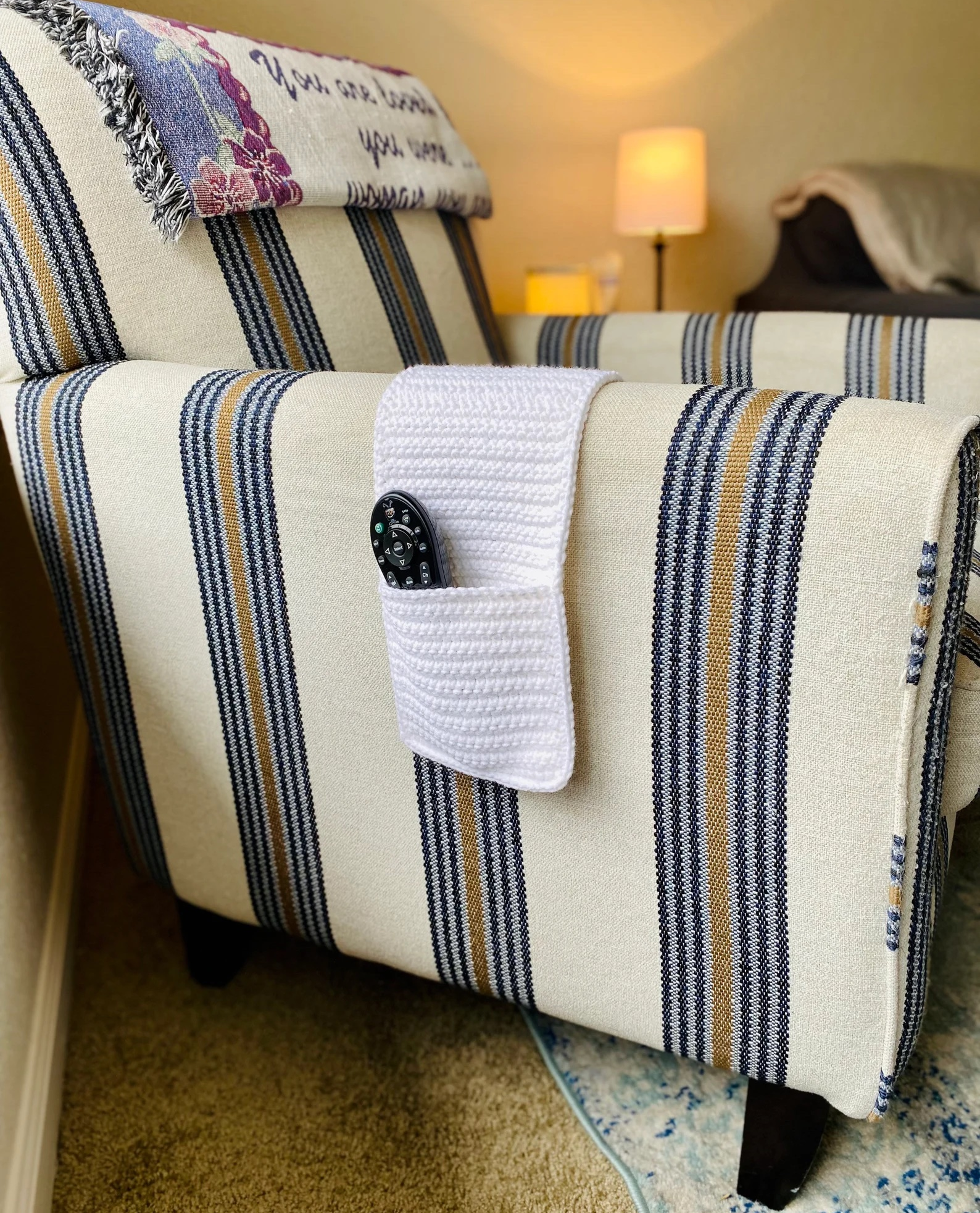 the white caddy draped over an armchair's armrest and holding a remote