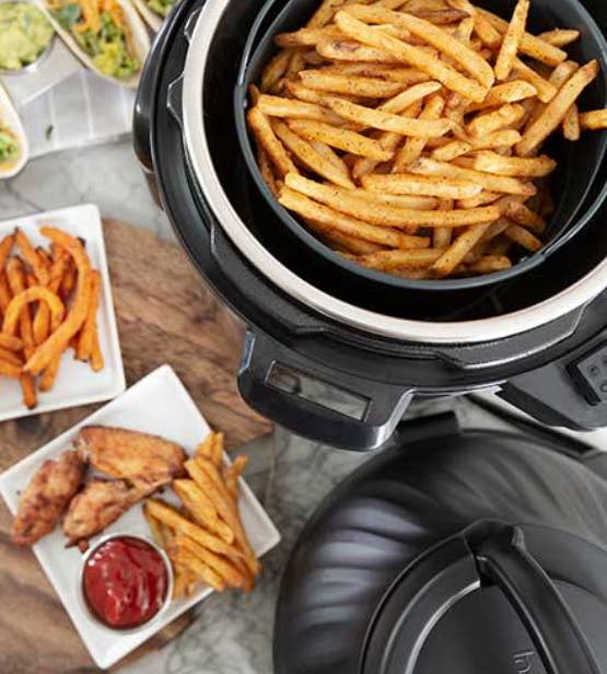 A Instant Pot with French fries in it and a plate of chicken and fries with ketchup