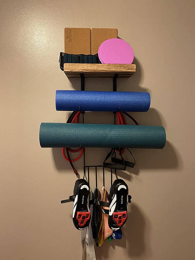 reviewer image of the storage shelves holding an assortment of workout equipment
