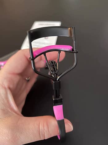a pink and black eyelash curler