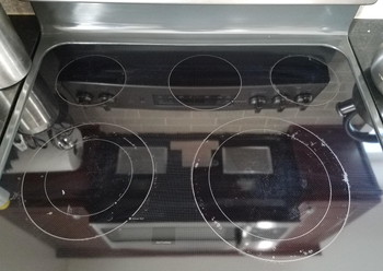 reviewer photo of their stovetop now clean after using the product