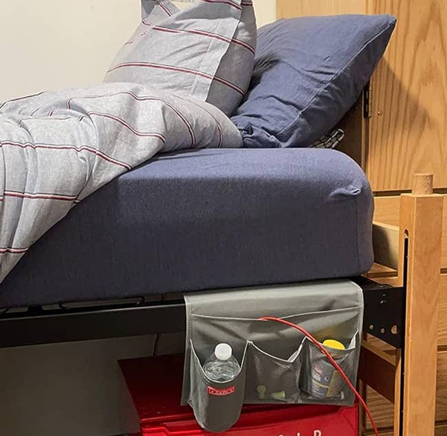 gray bedside caddy attached to a dorm bed