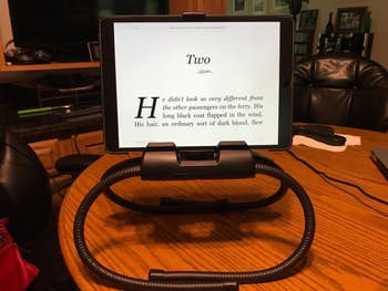 another reviewer's stand with its legs folded under it, sitting on a tabletop holding a tablet